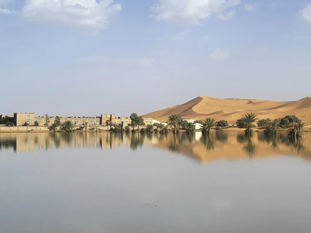 An oasis is reflected in a lake caused by heavy rainfall in the desert town of Merzouga, near Rachidia, southeastern Morocco, Wednesday, Oct. 2, 2024. (AP Photo)